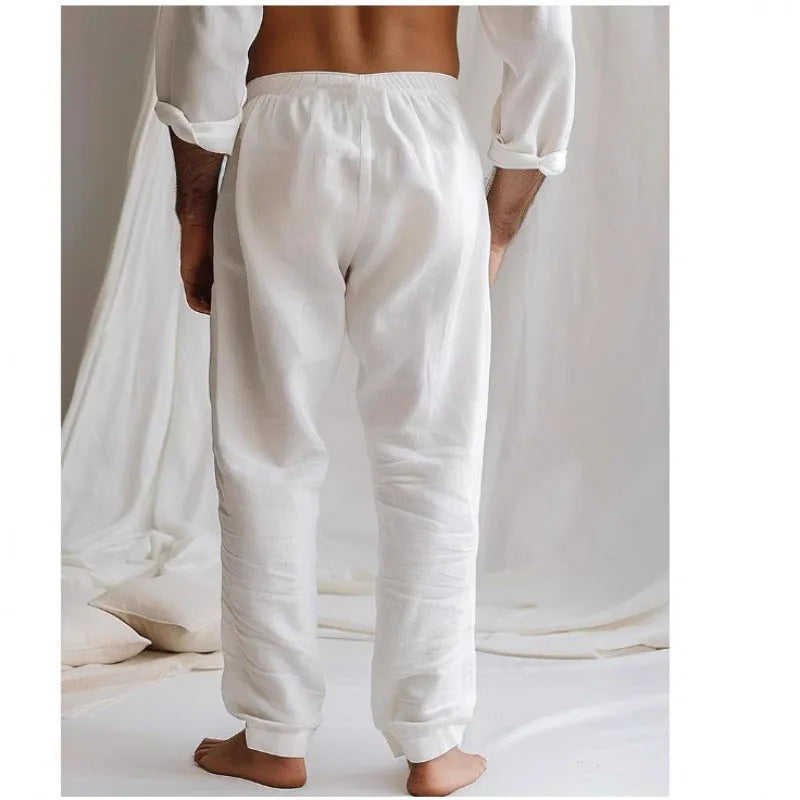 Men's light blue cotton linen loose-fit trousers with an elastic drawstring waist and straight legs.