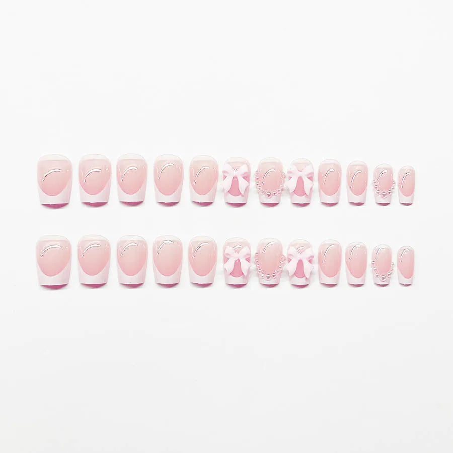 Set of 24 short, square false nails with pre-designed bow, tulip, starry sky, and leopard print patterns for a French manicure.