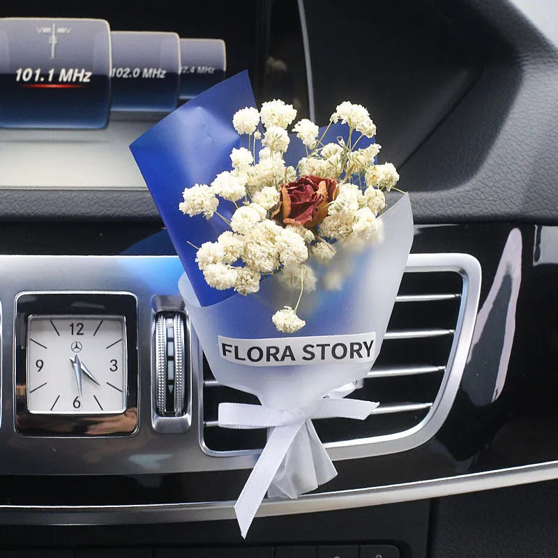 Mini dried flower bouquet clipped onto a car air vent, showing pink and white floral style.