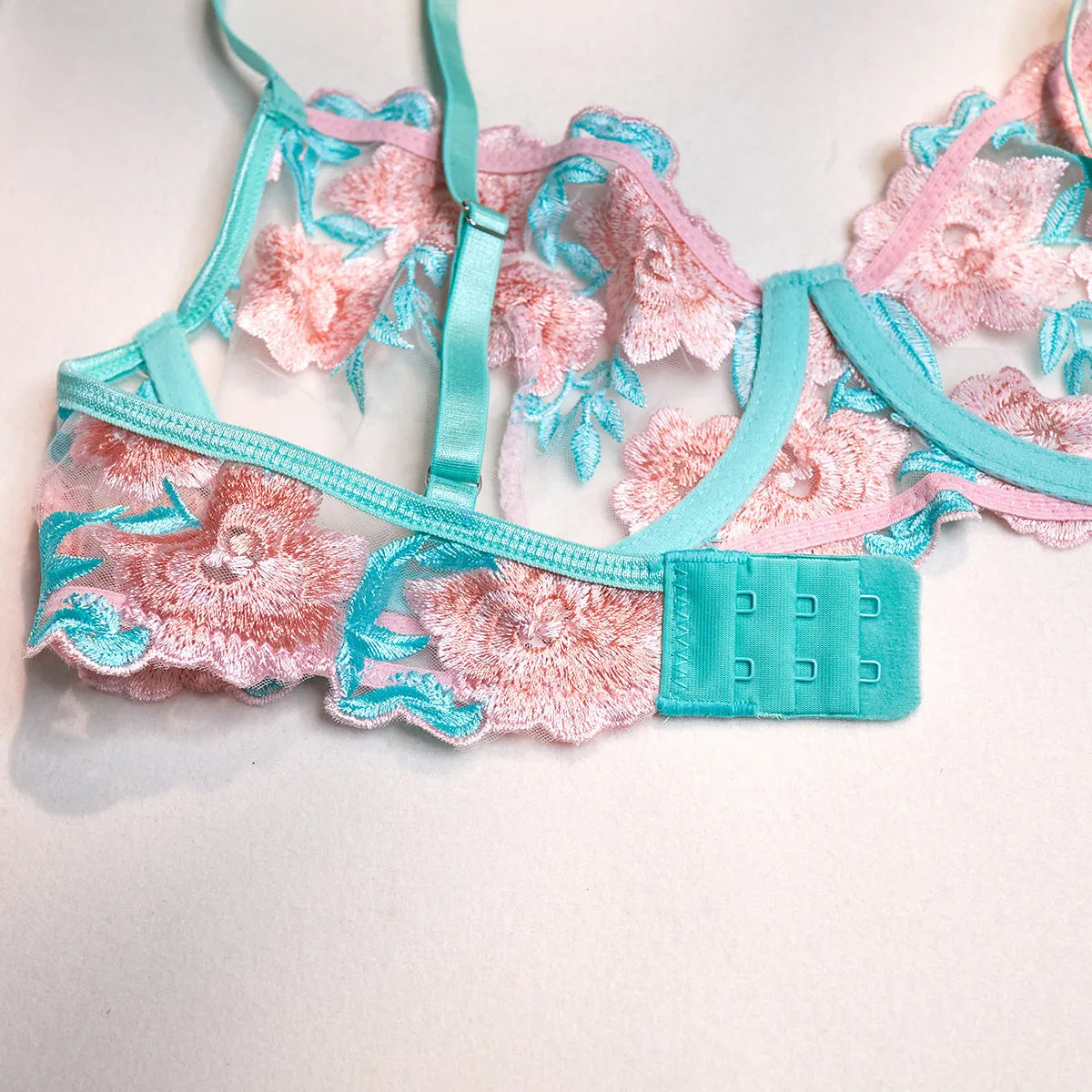 Pink women's bikini set with embroidered mesh pettiskirt and matching strappy top.