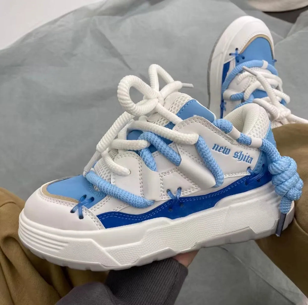 Women's grey chunky platform sneakers with thick soles and lace-up front