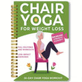Green coil-bound 30-day chair yoga training notebook with open pages showing exercise plans