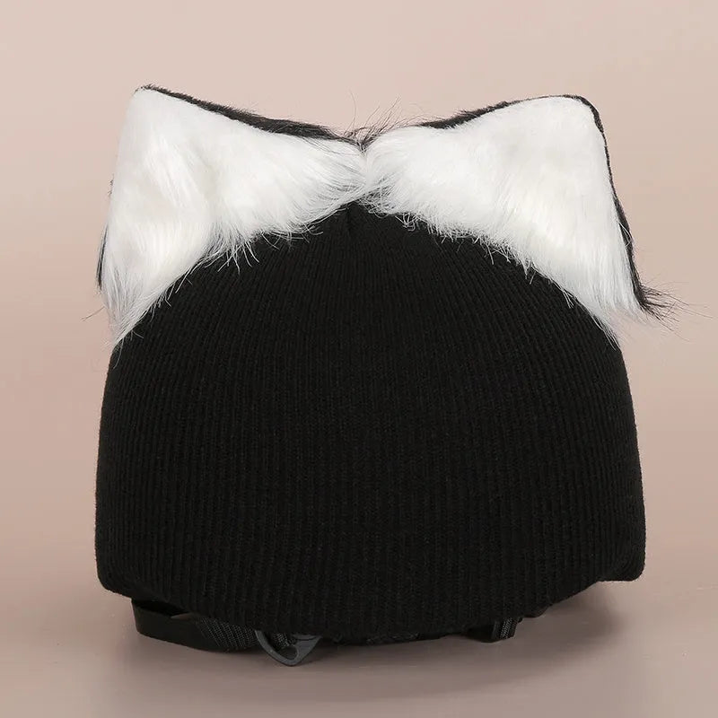 Soft plush cartoon character cover stretched over a pair of black on-ear headphones.
