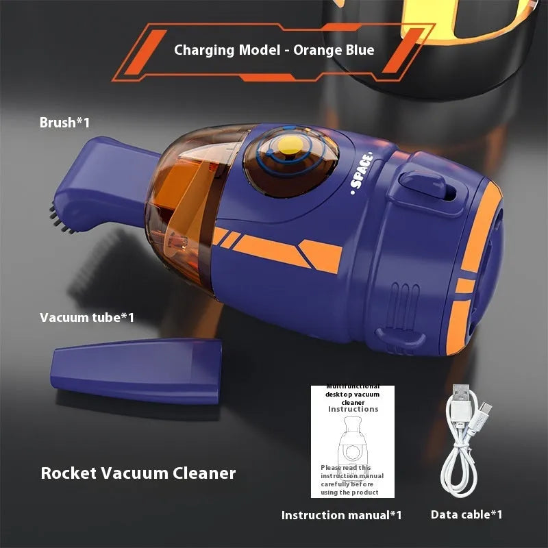 Blue rocket-shaped USB rechargeable handheld desktop vacuum cleaner on a wooden desk next to a keyboard