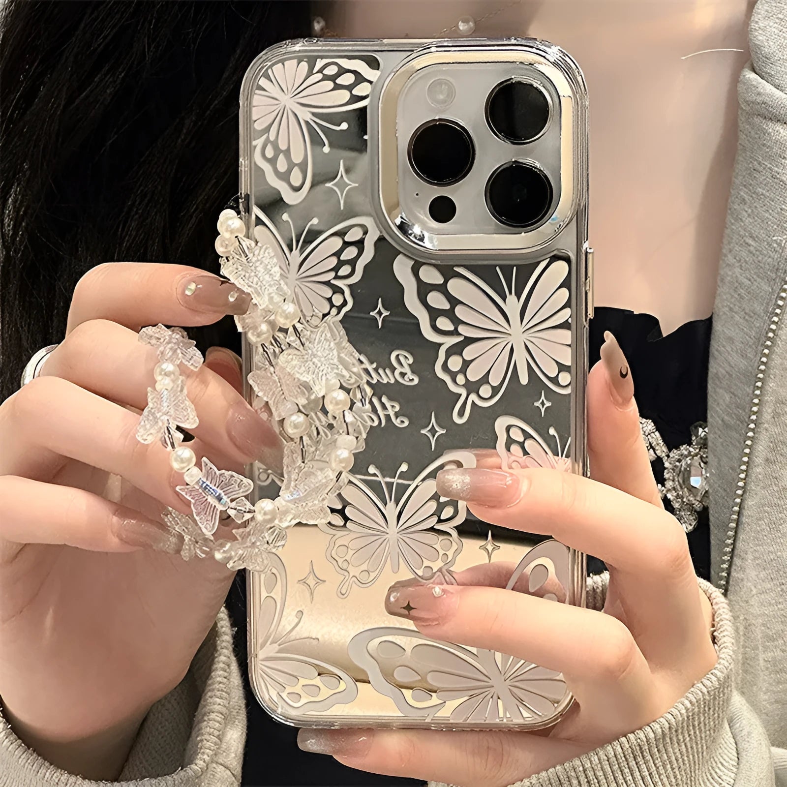 Transparent iPhone 15 Pro Max case with integrated mirror and bow decoration on back