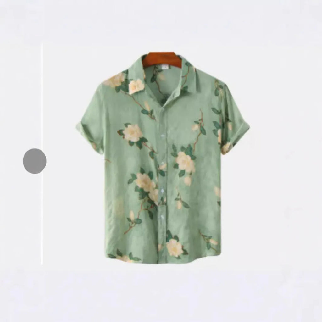 A man wearing a short sleeve floral print Hawaiian shirt with a button-up front and lapel collar.