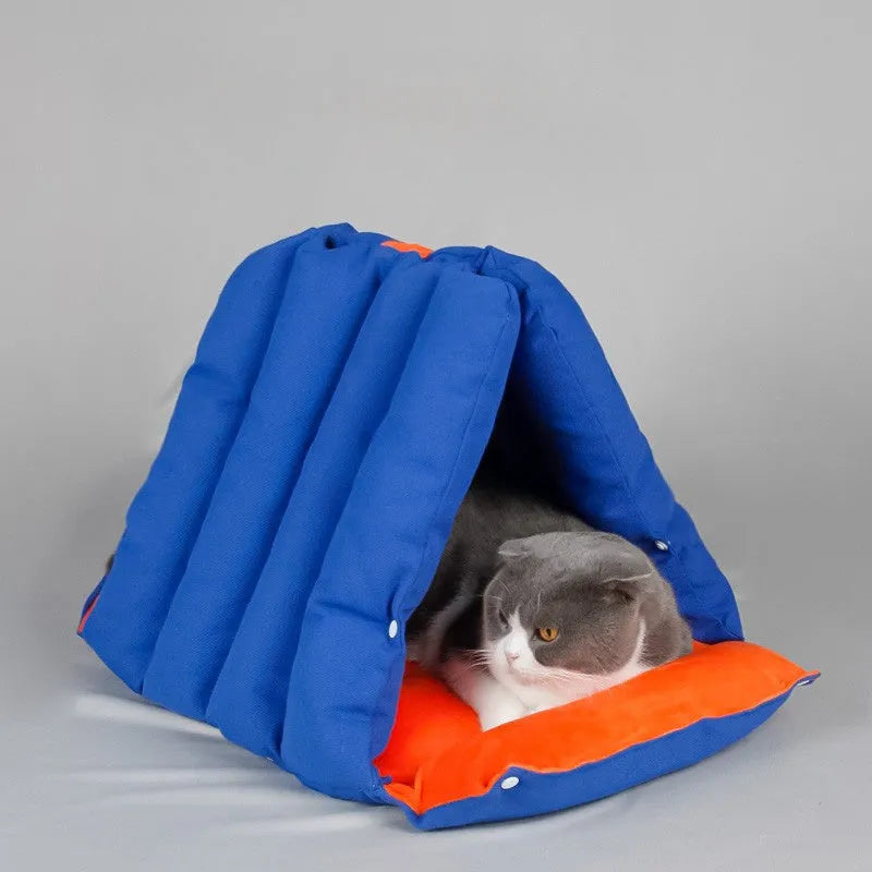 Blue triangular cat bed with removable cotton cover showing drilled holes for connecting multiple units