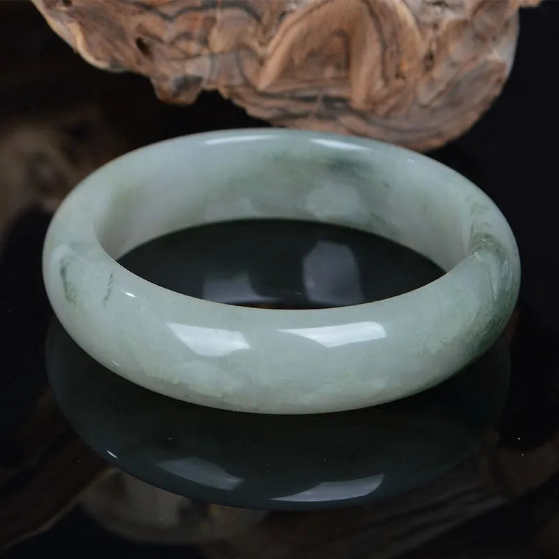 Natural Jinsi Jade Chinese style bangle bracelet on a plain background.