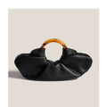 Niche Horn Bag acrylic ring handbag in black PU leather with fold design detail