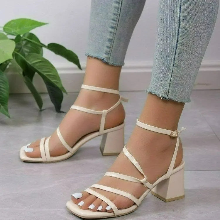 Plus size beige open toe slippers with an adjustable ankle buckle and square toe on a rubber sole.