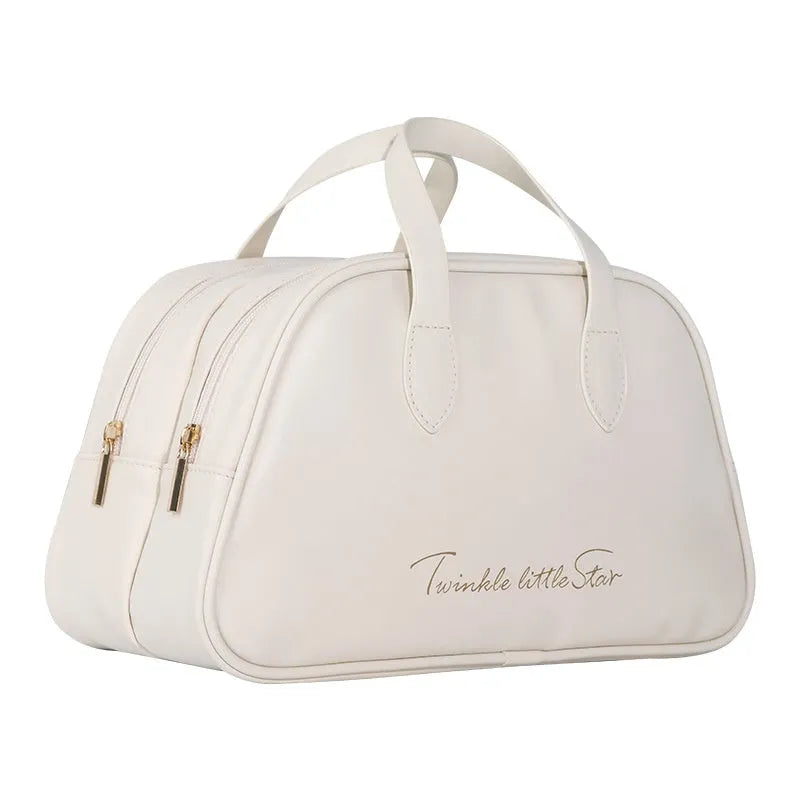 Large leather-look travel toiletry bag in caramel mocha colour with letter detailing, shown open.