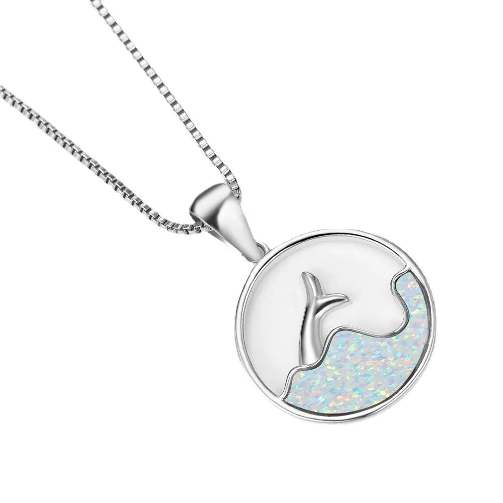 A round geometric pendant necklace with an electroplated opal finish on a copper chain.