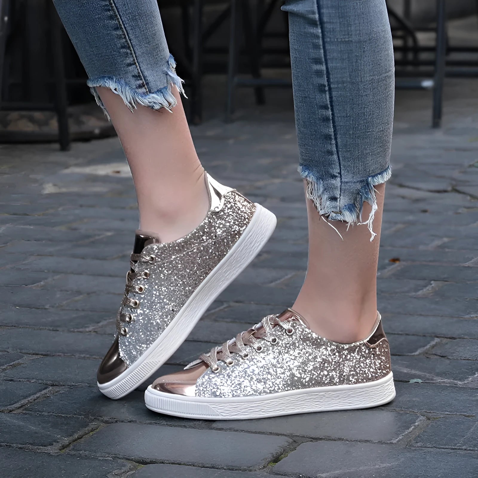 Women's black, gold, and pink sequinned low-top lace-up shoes on a white background.
