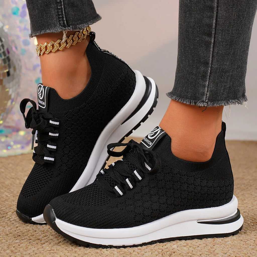 Women's black platform flat pumps with mesh upper and lace-up design on rubber sole
