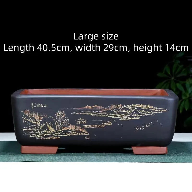 Handmade deep blue black rectangle purple clay bonsai pot on a wooden surface.