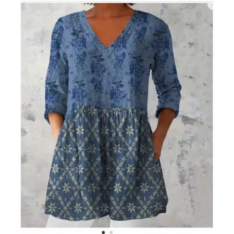 A woman wearing a loose-fit printed wave dress with 3/4 sleeves, showcasing the wide waist design.