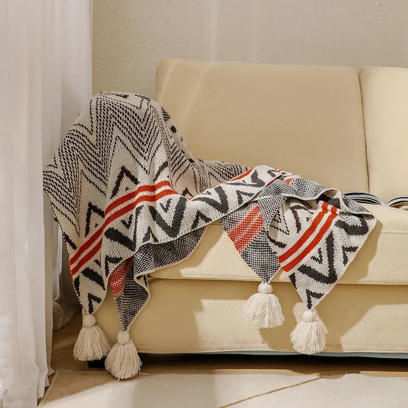 Bohemian-style acrylic knit sofa blanket with tassels in a geometric pattern