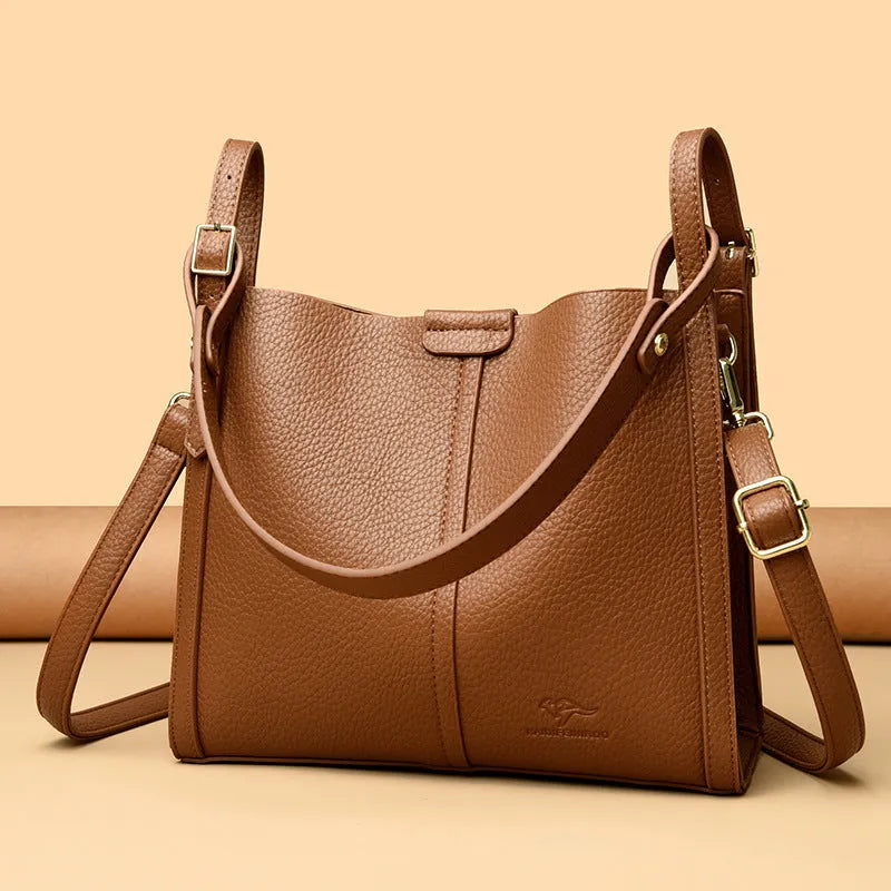 Brown retro-style ladies shoulder bag with single strap showing sewing line detailing and organisational compartments