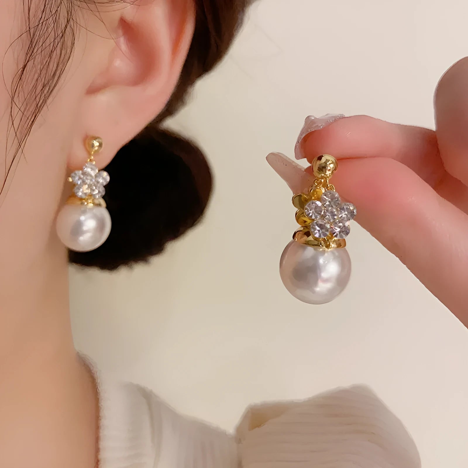 Female Korean style double-sided flower pearl earrings in gold plated copper with clip-on design