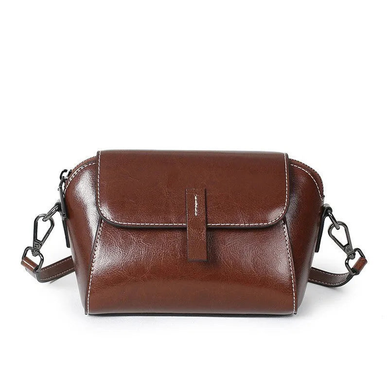 Women's brown oil wax leather messenger bag with crossbody strap and shell shape design