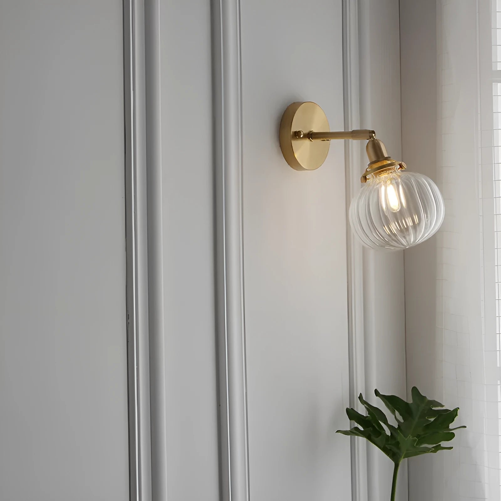Creative pumpkin-shaped wall lamp with a textured water ripple glass shade mounted on a white wall