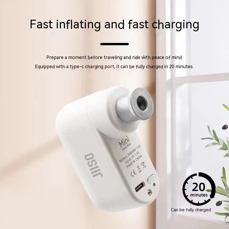 Compact black electric bike pump with USB-C port shown next to bicycle tyre and included air needles.