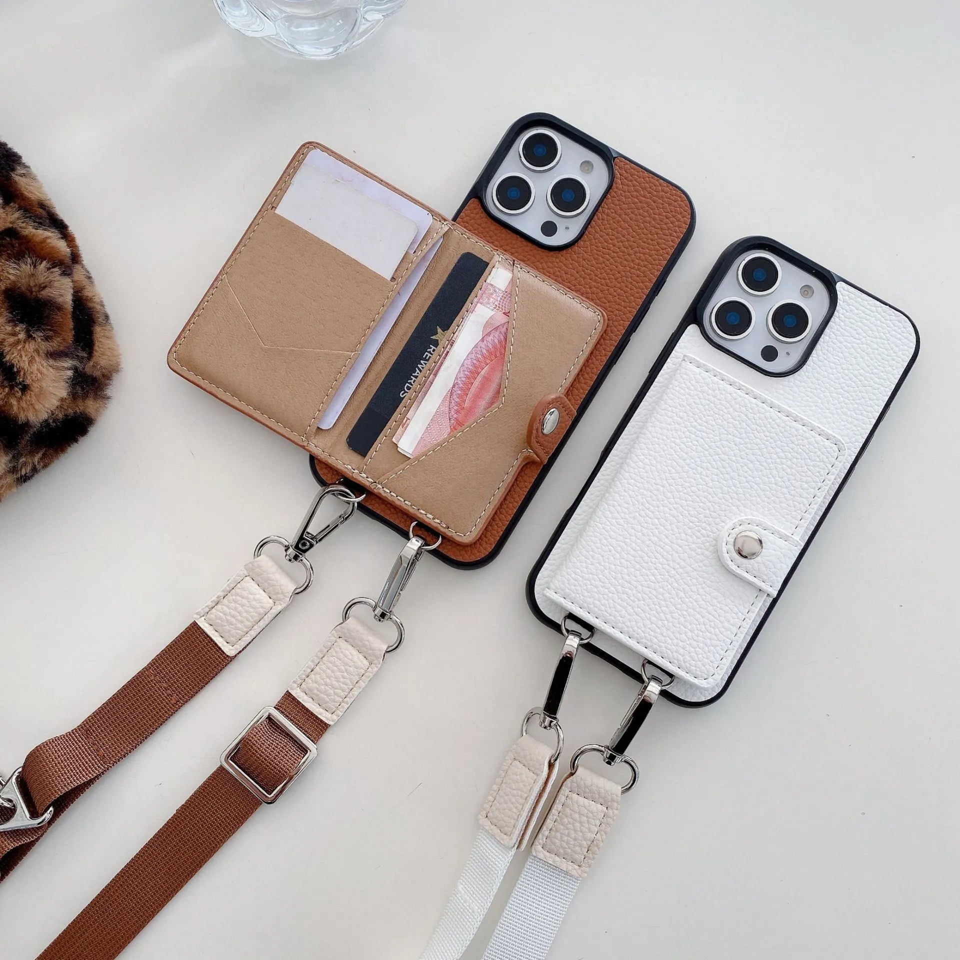 Polycarbonate leather lanyard phone case with card slot for iPhone, shown in black, brown, orange and white.
