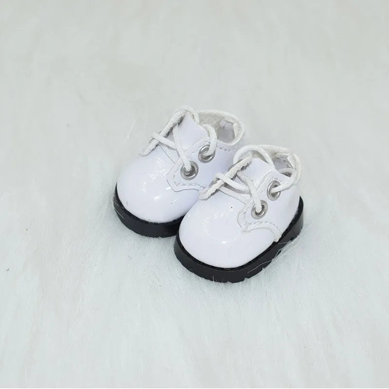 A pair of 17 cm high black doll shoes made from PU leather, shown as a keychain accessory.