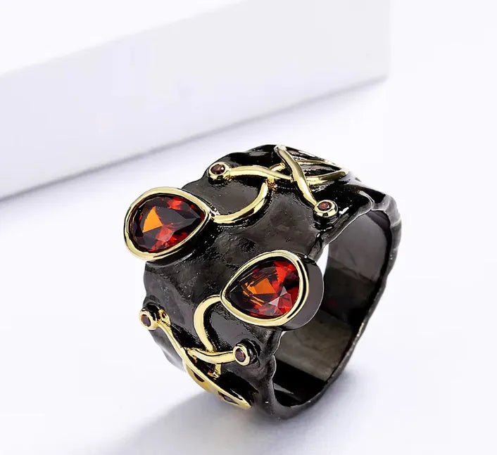 Women's black brass straight-pull oval ring on a neutral background