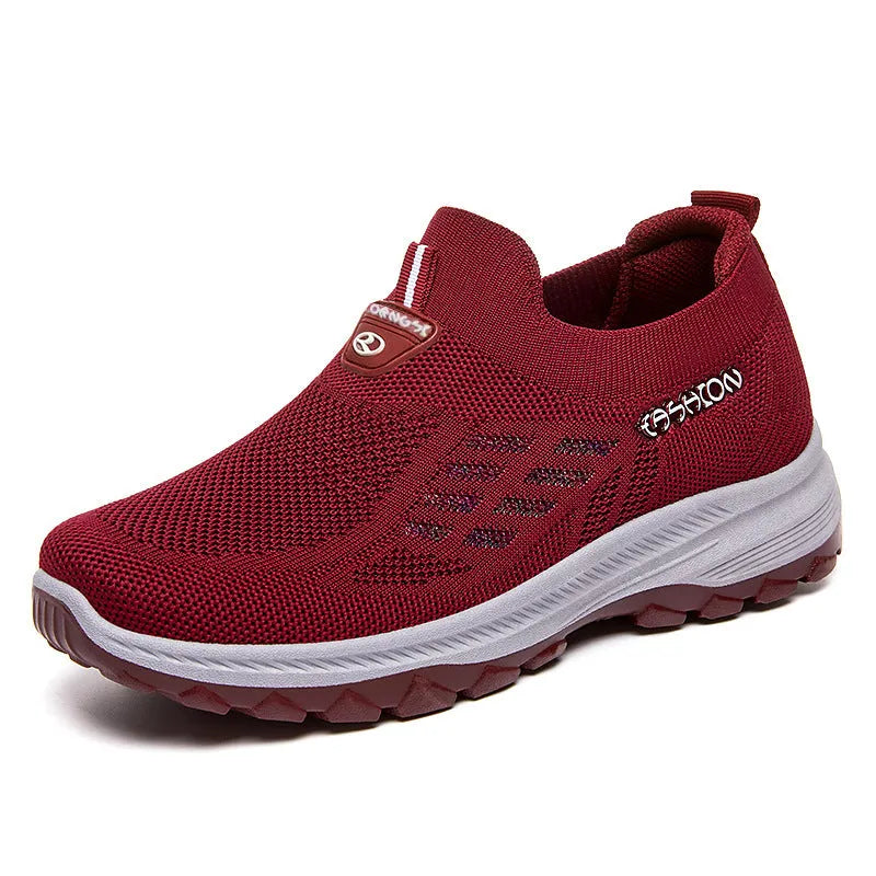 Women's flyknit slip-on casual shoes with mesh upper and PVC sole, shown in black, red, grey, and purple.