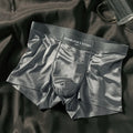 Men's ice silk underwear briefs in satin finish nylon fabric showing mid waist design and solid colour options