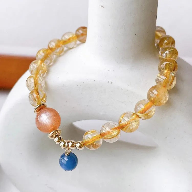Handcrafted natural gold rutilated quartz sunstone bracelet with diamond-shaped and round crystal beads for women