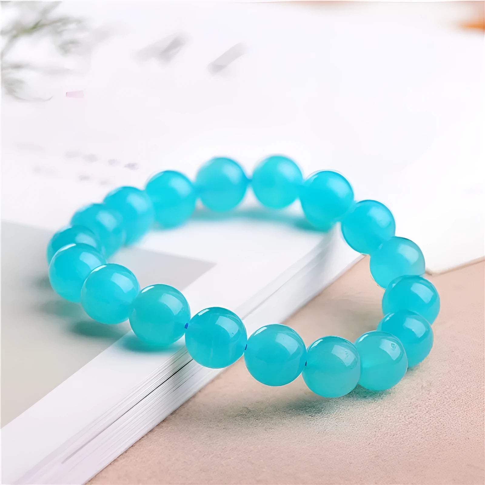 Loose natural blue-green Amazonite beads in various sizes from 6mm to 13mm on a white surface.