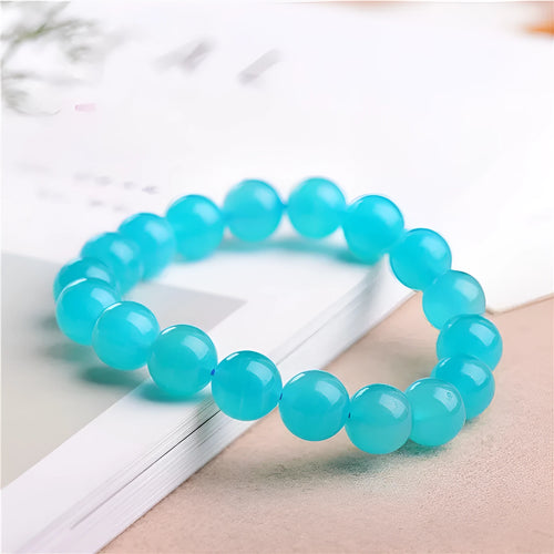 Loose natural blue-green Amazonite beads in various sizes from 6mm to 13mm on a white surface.