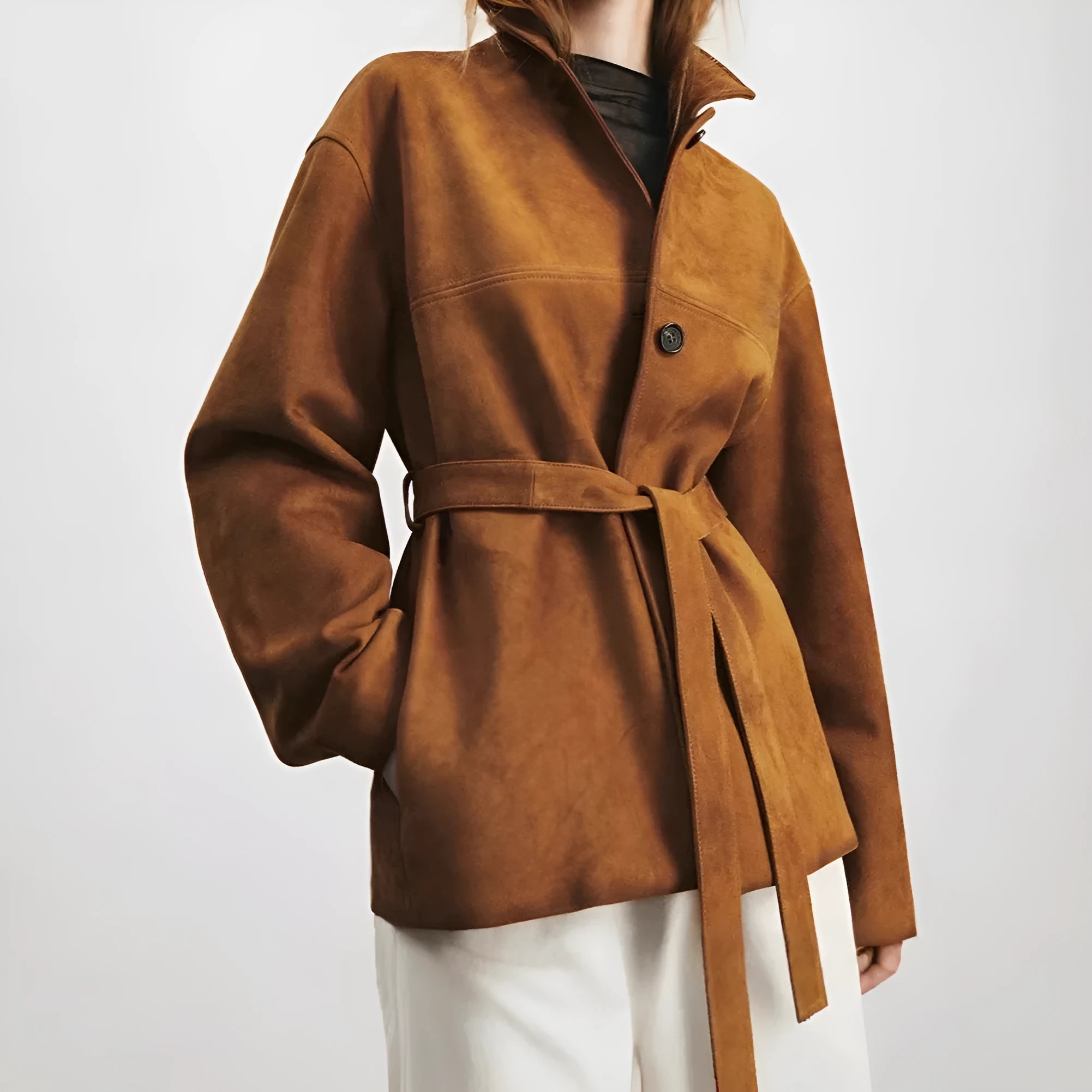Yellow Brown retro cashmere coat with Peter Pan collar and leather stitching on a hanger.