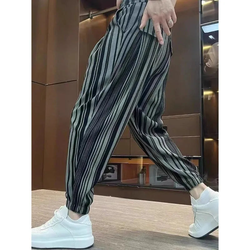 Men's cropped ankle-tied ice silk pants in dark gray stripe pattern, front view on model