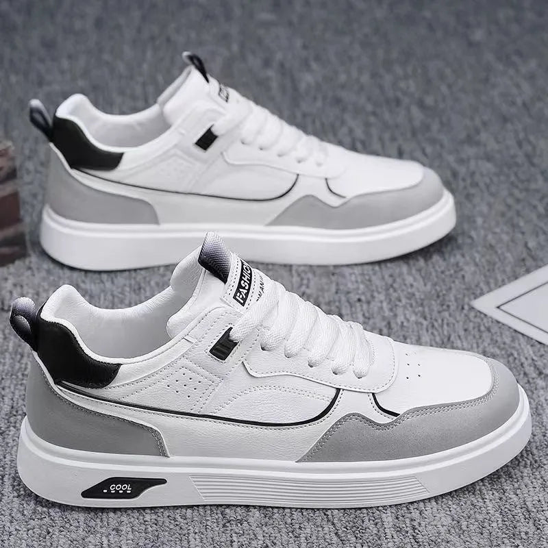 Men's low-top casual canvas shoes in beige with leather stitching detail on a white background.