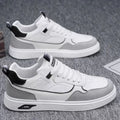 Men's low-top casual canvas shoes in beige with leather stitching detail on a white background.