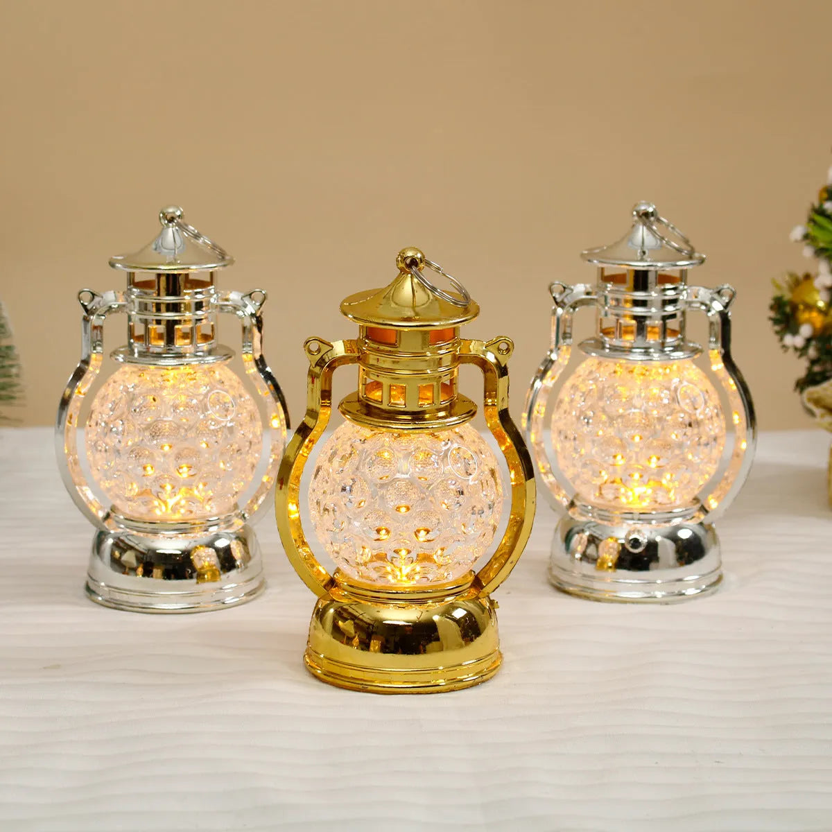 Small retro-style oil lamp LED night light in gold or silver finish on a table.