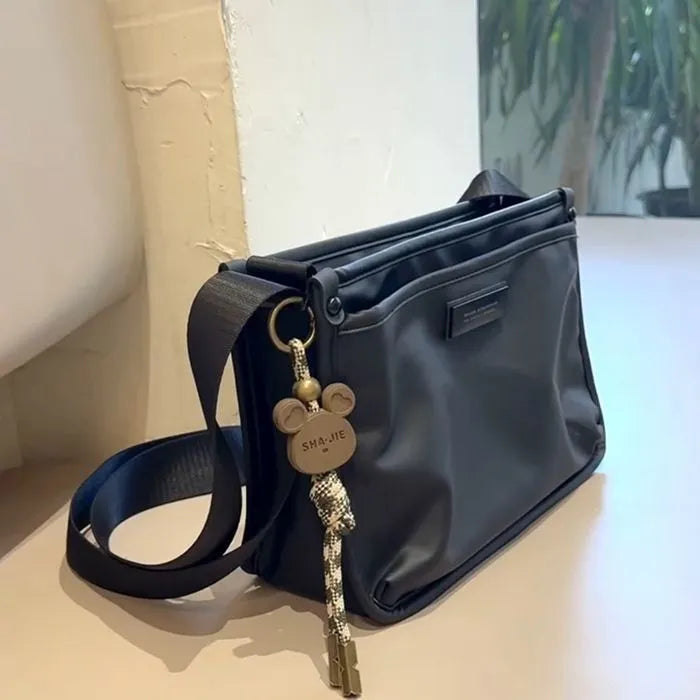 Retro-style small square crossbody bag in Oxford cloth for unisex casual and travel use