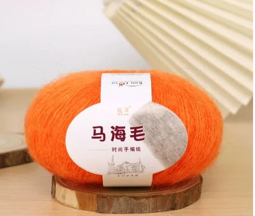 A 200g ball of mohair Inverness thread in a chosen colour, next to a measuring tape showing 180cm for the finished scarf length.