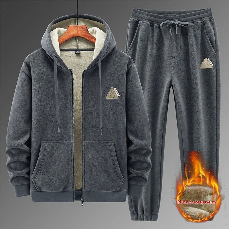 Man wearing a grey hooded sweater and matching trousers from a casual sports suit set.