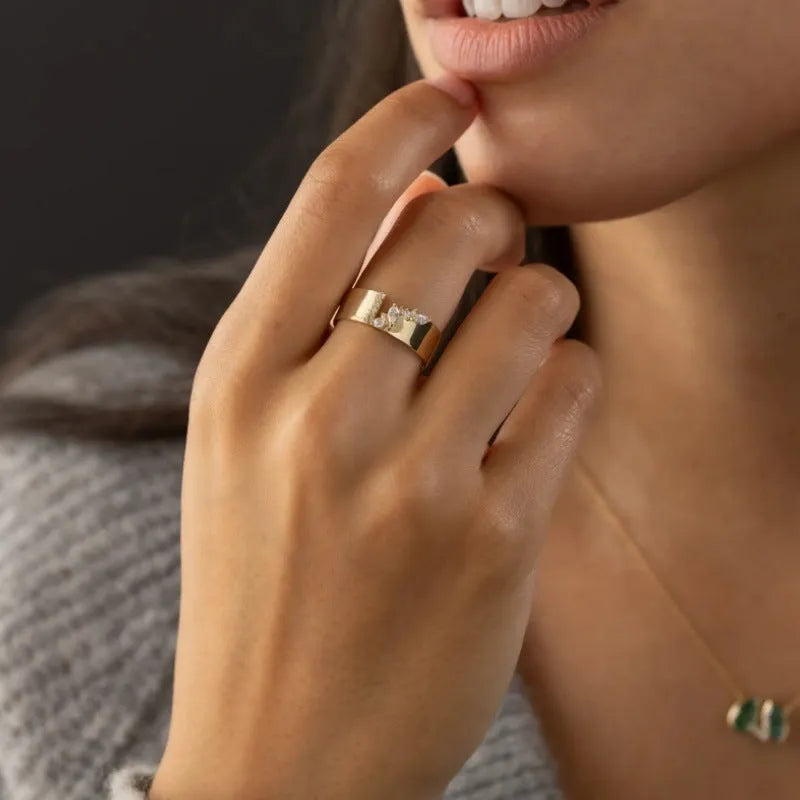 Gold electroplated women's ring with shining zircon stone on a copper band.