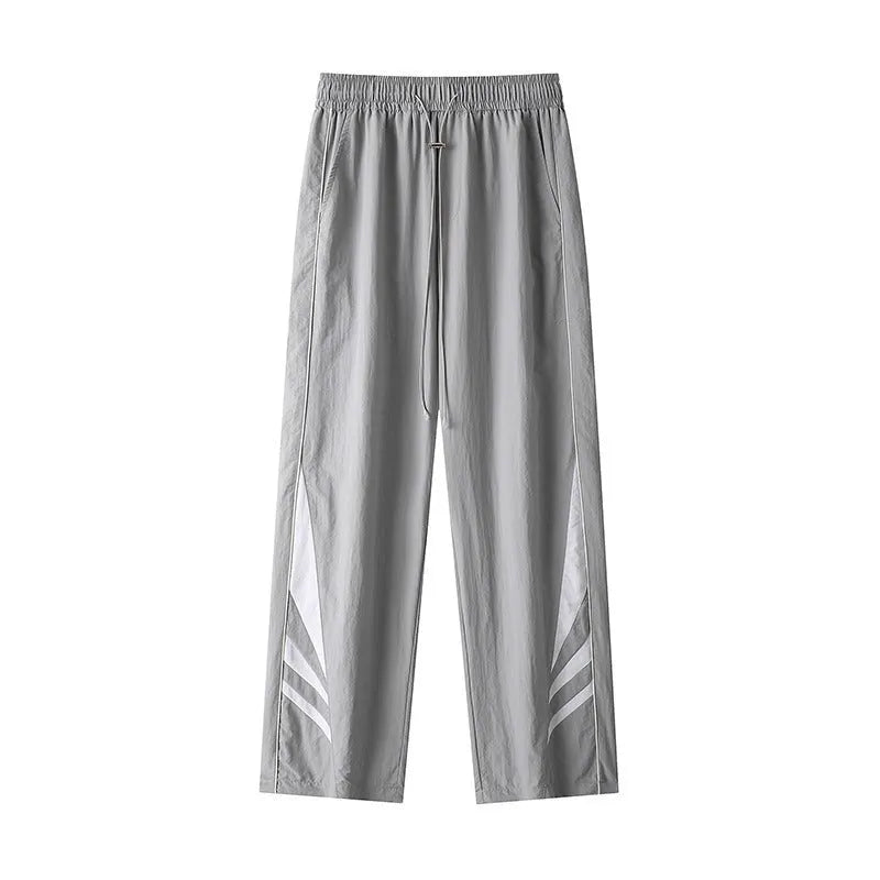 Plus-size men's straight-leg casual sports trousers in grey, showing loose fit and elastic waist.
