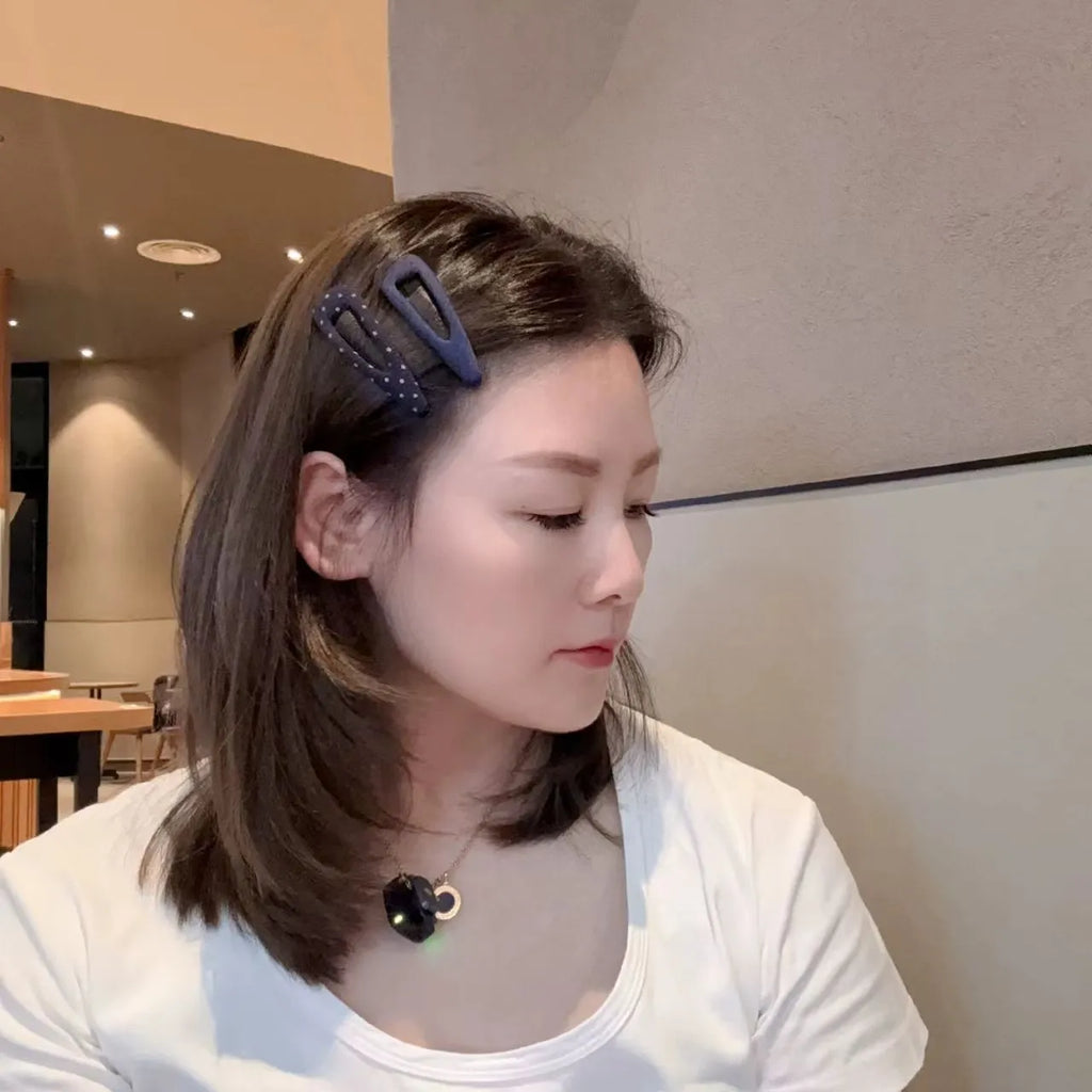 French retro style hair barrettes in triangle and water drop shapes with dark denim and polka dot patterns.