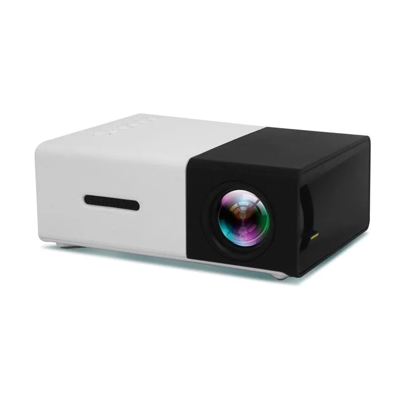 Mini LED projector YG300 in white and yellow, with lens and ventilation grilles, on a table