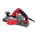 Red aluminium-shell electric wood planer with 82mm planing width and 1400W motor for carpentry tasks.
