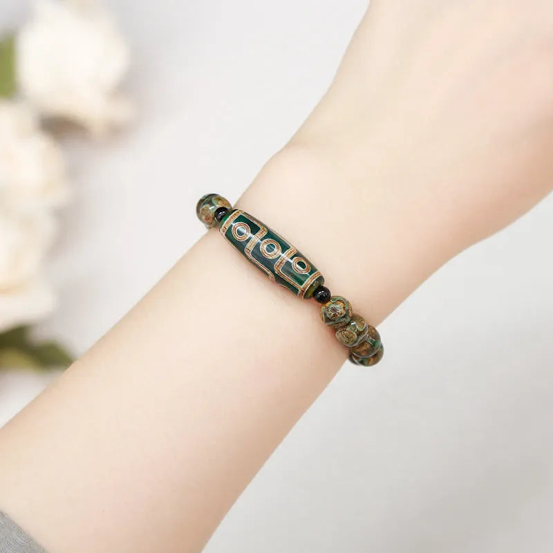 Green Dzi bead barrel shaped bracelet with 8mm handmade beads and Tibetan-inspired design