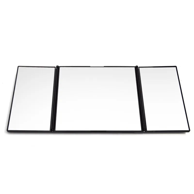 Silver folding car makeup mirror shown both closed and open on a car dashboard.
