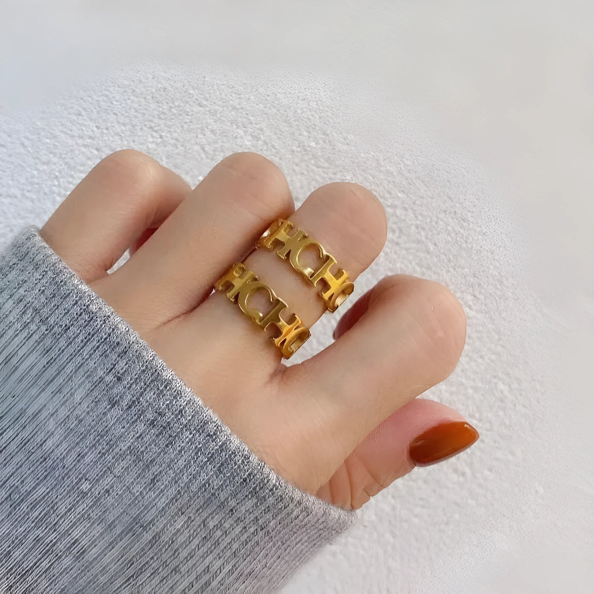 Gold titanium steel unisex letter ring with hollowed cut design, sizes 6 to 9